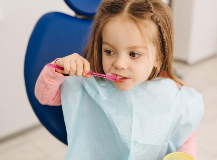 Cute girl brushing teeth dentistry